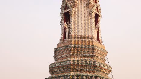 looking up at towering detailed pagoda spire in a buddhist temple complex in the rattanakosin old town of bangkok, thailand