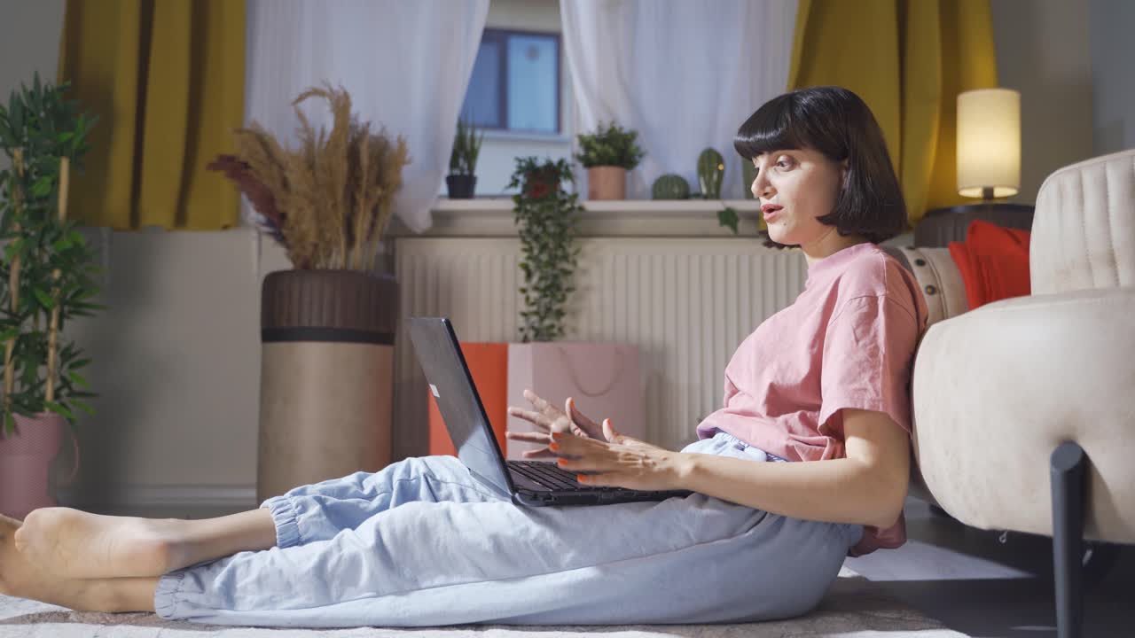 Woman watching movie on laptop with happy expression.