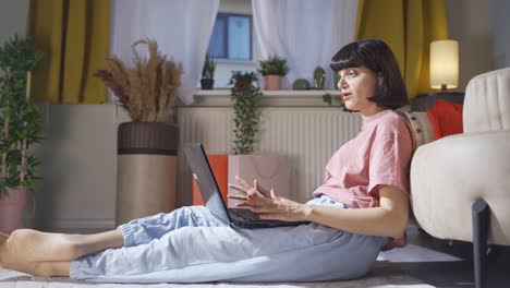 woman watching movie on laptop with happy expression.