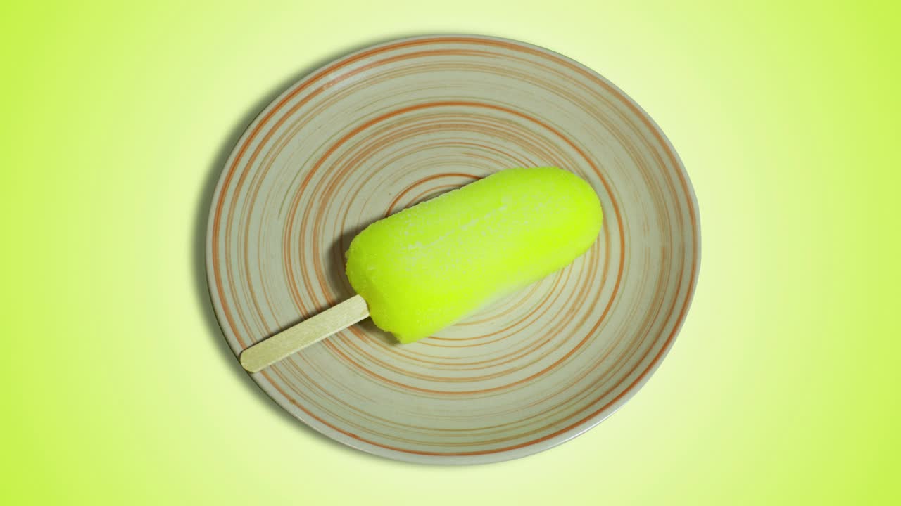 Yellow popsicle on a plate