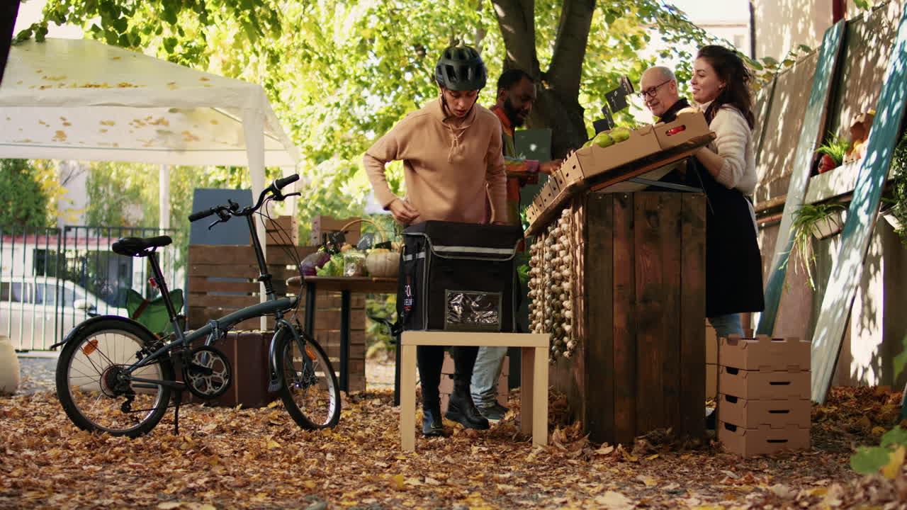 People shopping at an outdoor farmers market in autumn