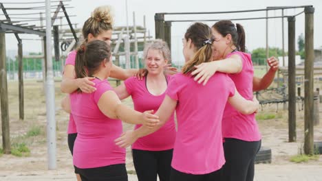 Female-friends-enjoying-exercising-at-boot-camp-together