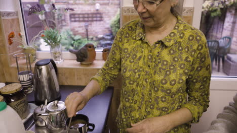 woman making tea in a kitchen