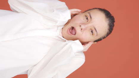 Vertical-video-of-Fear-reaction-of-woman-looking-at-camera.-Coward-woman.