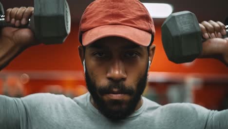 man lifting dumbbells in the gym