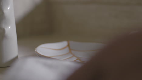 View-of-woman-hand-putting-on-plate-rolls-of-towels