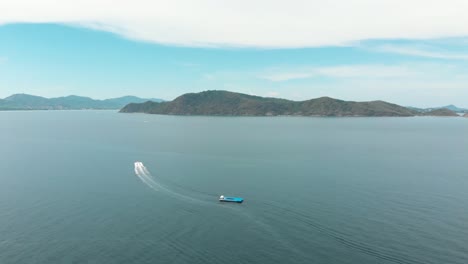 speed boat cruising through the waters between koh hey and mainland phuket, thailand - aerial wide panoramic shot