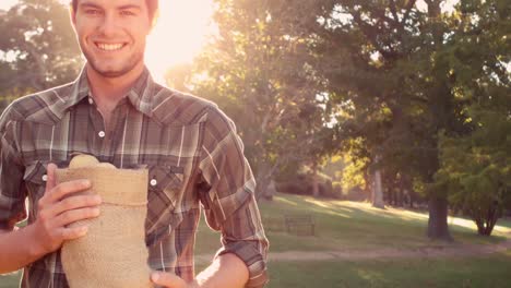 Handsome-man-holding-bag-of-vegetables