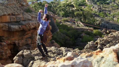 Climber-cheering-after-reaching-the-top-of-cliff-4k