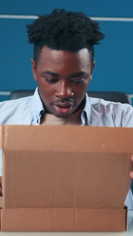 unboxing a surprise package at an office desk in the afternoon