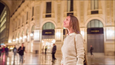 woman exploring a night-time city shopping area