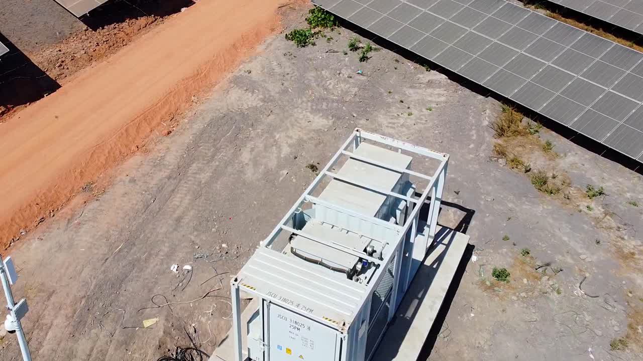 Inverter station container at a solar farm in Jambur, Gambia. Aerial
