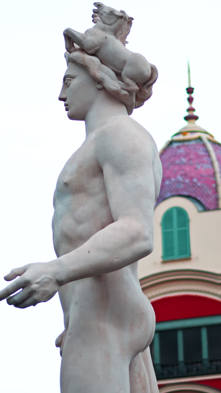 Nice, France - December 8, 2024: Apollo statue in the Fontaine du Soleil at Place Massena. Vertical