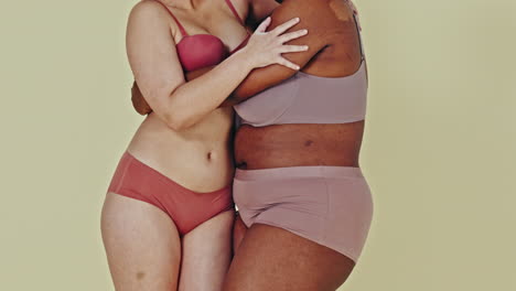 two women embracing in underwear