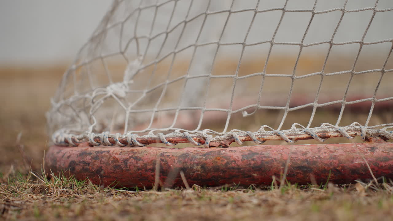 postgoal tranquility on vacant pitch, stillness and satisfaction following striking sports achievement, serene and triumphant atmosphere lingering on deserted sports field after scoring moment