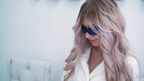 woman-in-glasses-undergoing-laser-epilation-in-clinic