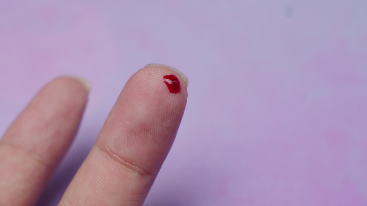 Alcohol Swab Pad Cleaning Off Fresh Red Blood From A Punctured Finger.