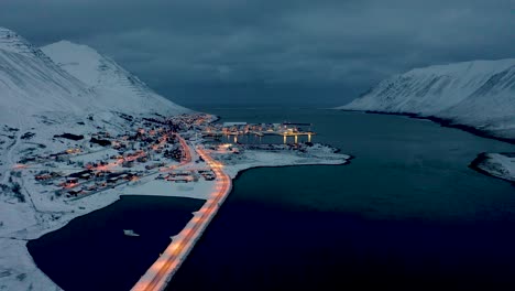 amazing illuminated town of siglufjordur in north iceland at night - aerial shot