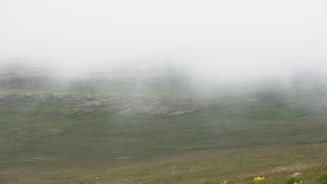 mountain top covered by eerie dense fog