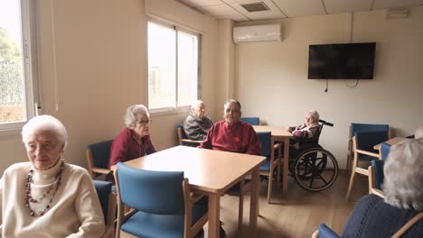 old people gathering in lounge of retirement home