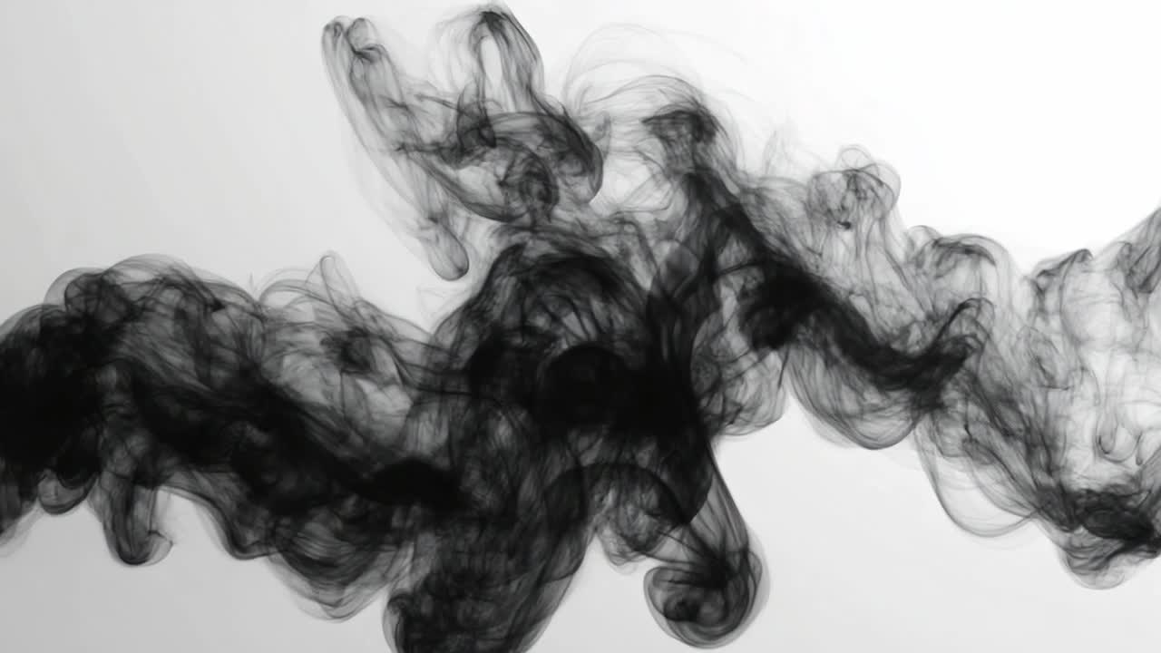 Black smoke on white background. Black smoke swirls gracefully against a stark white backdrop, creating an ethereal and abstract visual effect.