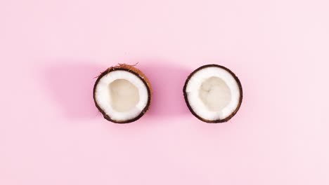 two half of coconut rotate on pastel pink theme. stop motion