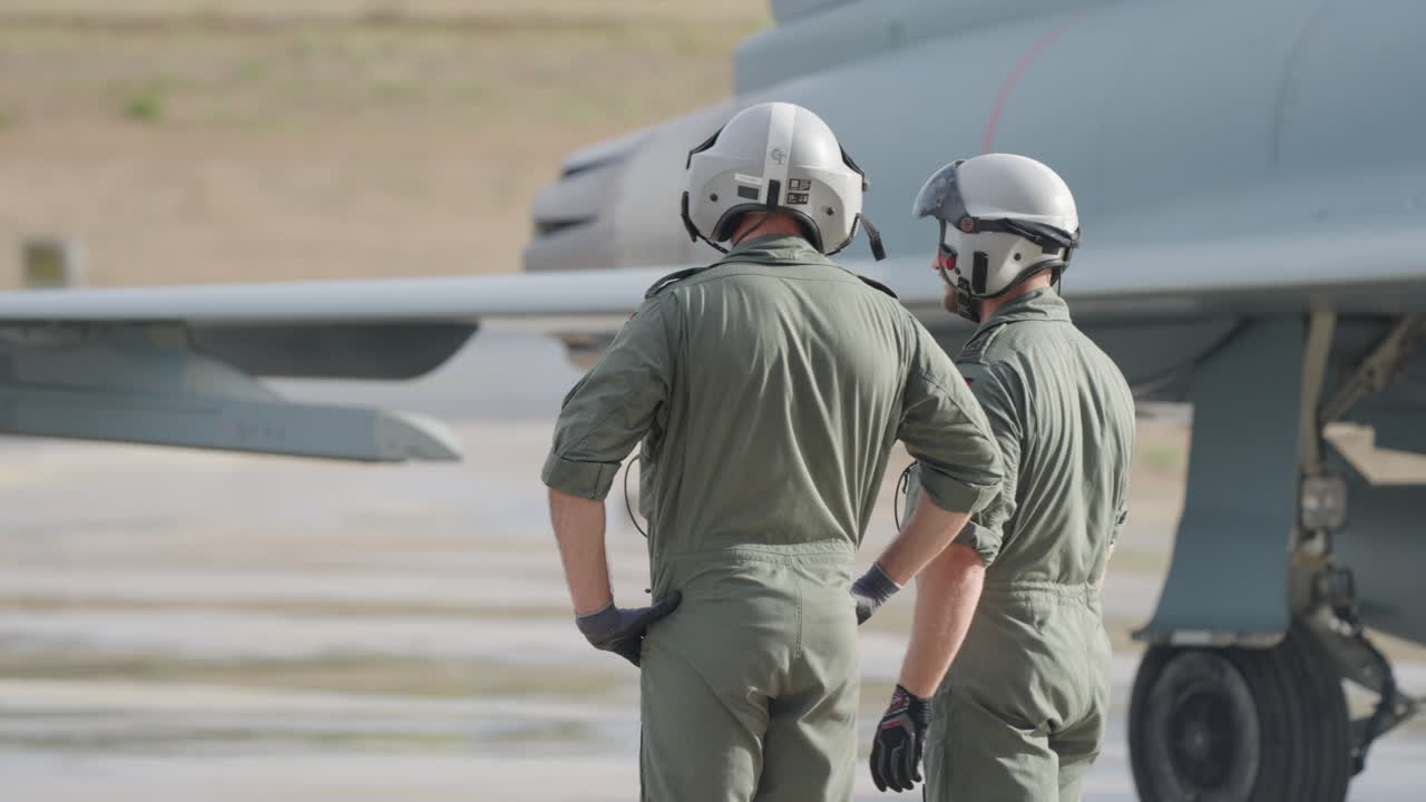 Pilots standing near an airplane