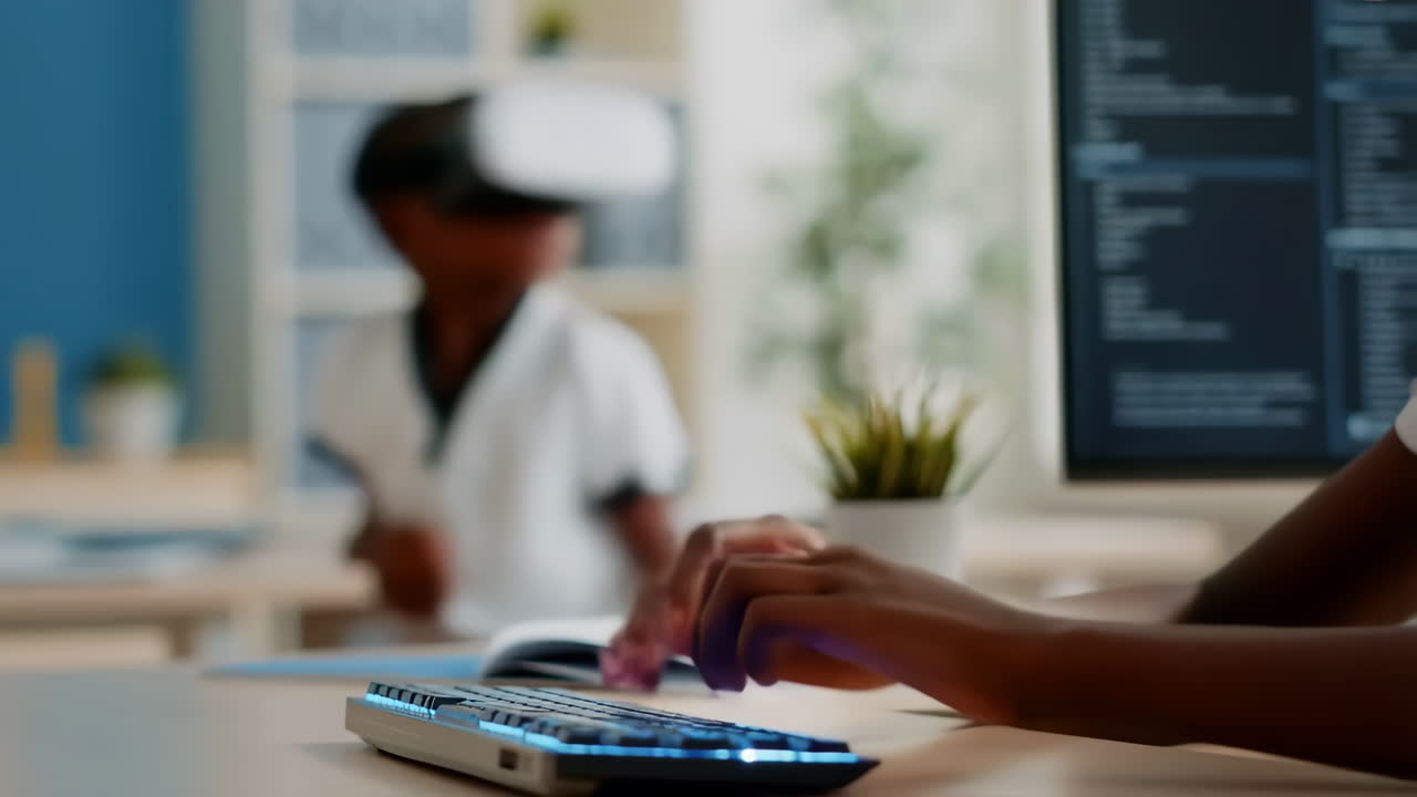 Children using a VR headset and typing on a computer keyboard