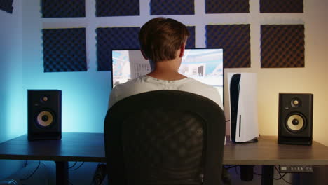 boy gaming on his playstation 5 with a ps5 controller in an rgb led room at night, wide