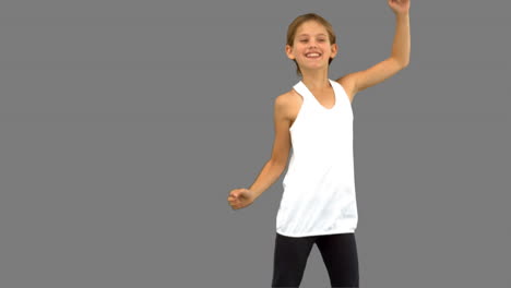 little girl dancing on grey screen