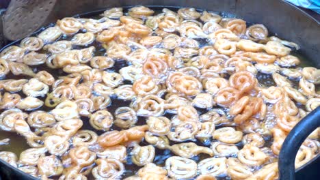 cooking of bangladeshi street food jalebi. south asian street food cooking on daytime. traditional street food of bangladesh. indian street sweet jalebi