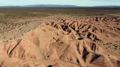 Aerial-rotates-over-flat-clay-landscape-with-badland-smooth-erosion