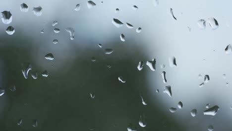 Zooming-In-Shot-Of-Wet-Raindrops-On-Window-Glass-Surface