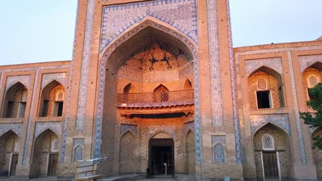 the evening sun lightling up the beautiful madrasain khiva, uzbekistan, central asia