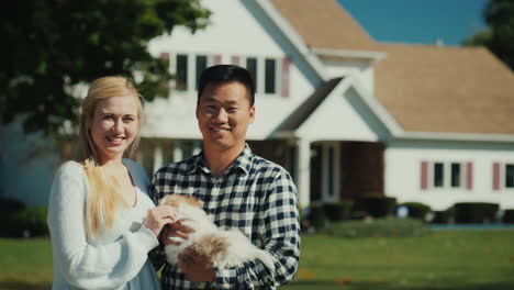 couple with house and puppy portrait