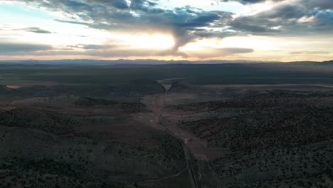 dramatic sunset sky over parowan gap, narrow passage through red hills in southwestern utah