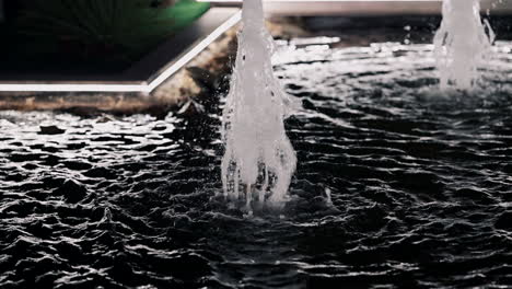 Water fountain jets splashing into basin