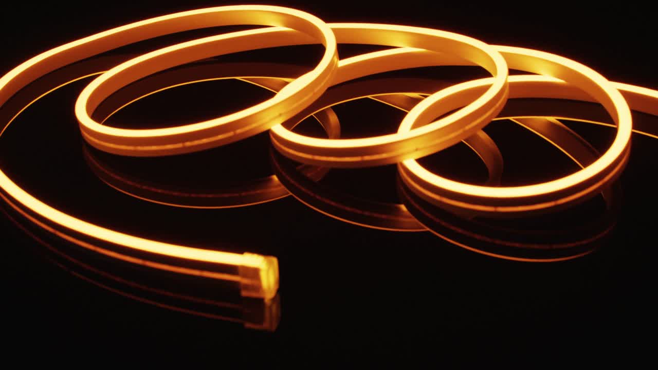 검은색 배경 위에 나선형 모양의 오렌지색 네온 불빛의 애니메이션