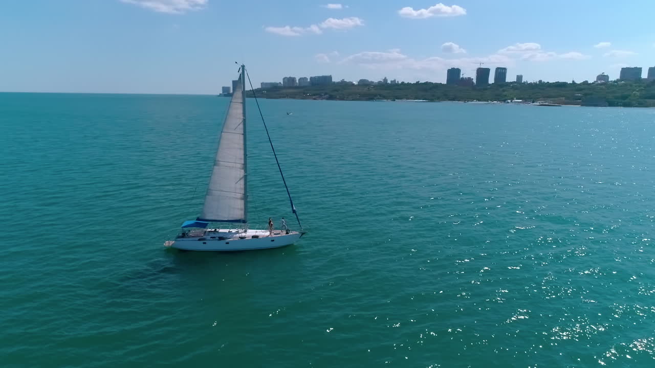 Aerial view of sailing yacht. Drone shot of sail boat traveling in calm waters