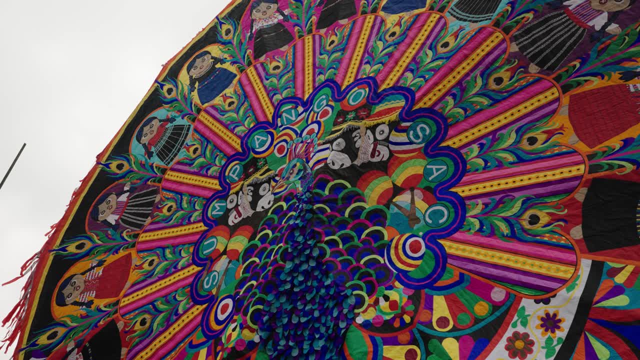 Low angle view of colorful handmade peacock kite displayed at Sumpango festival