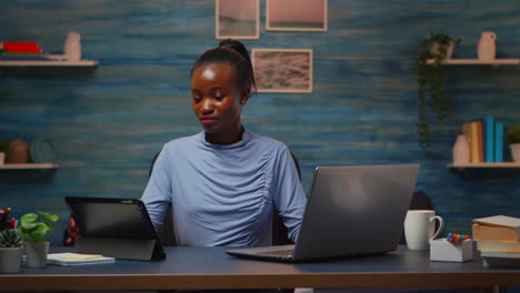 African-woman-using-laptop-and-tablet-in-same-time-overwork