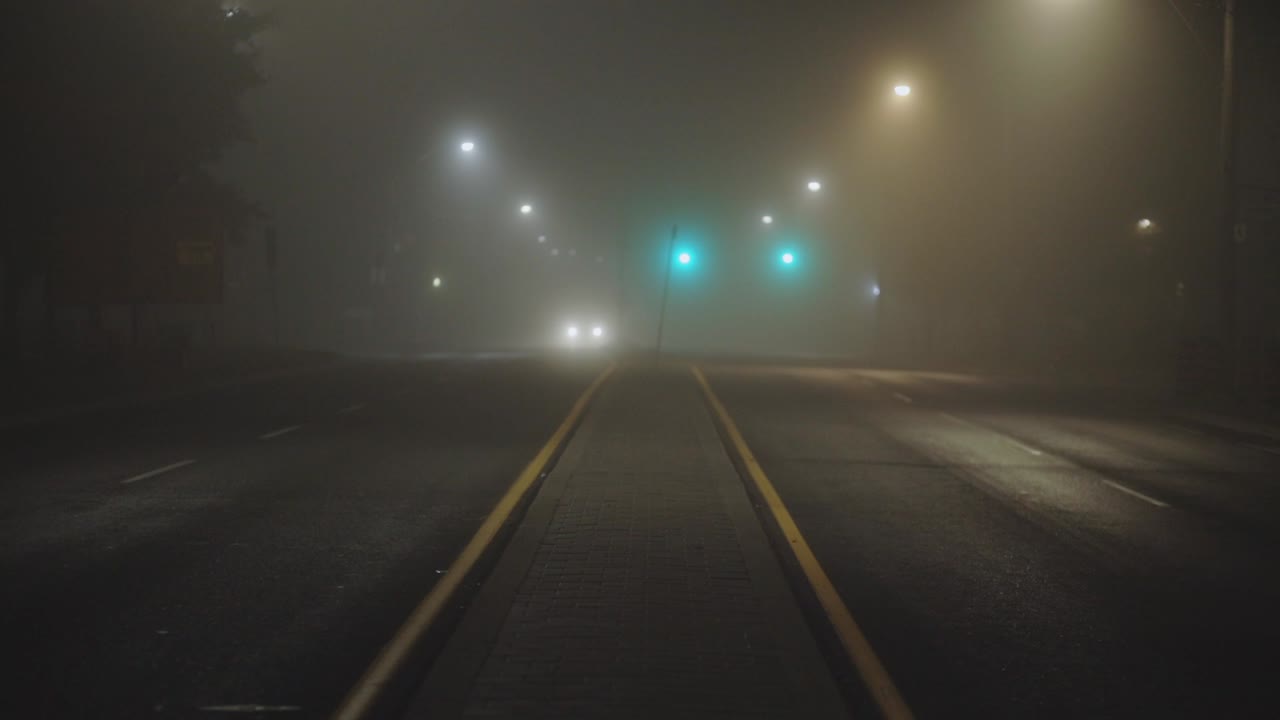 Bright Headlights Of A Car Driving On Foggy Road At Night - wide