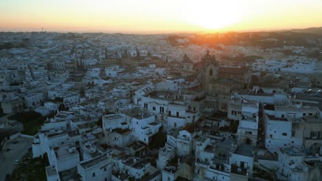 Bright-colorful-sunset-over-the-village-Ostuni-with-white-buildings-in-Italy