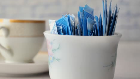 spoon of white sweetener on a black background