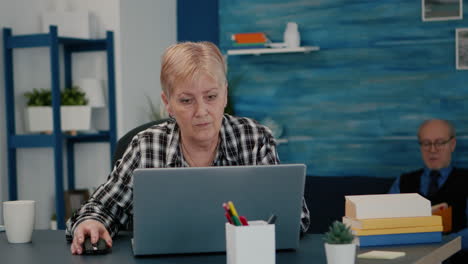 anciana mujer de negocios de mediana edad trabajando en una computadora portátil desde casa