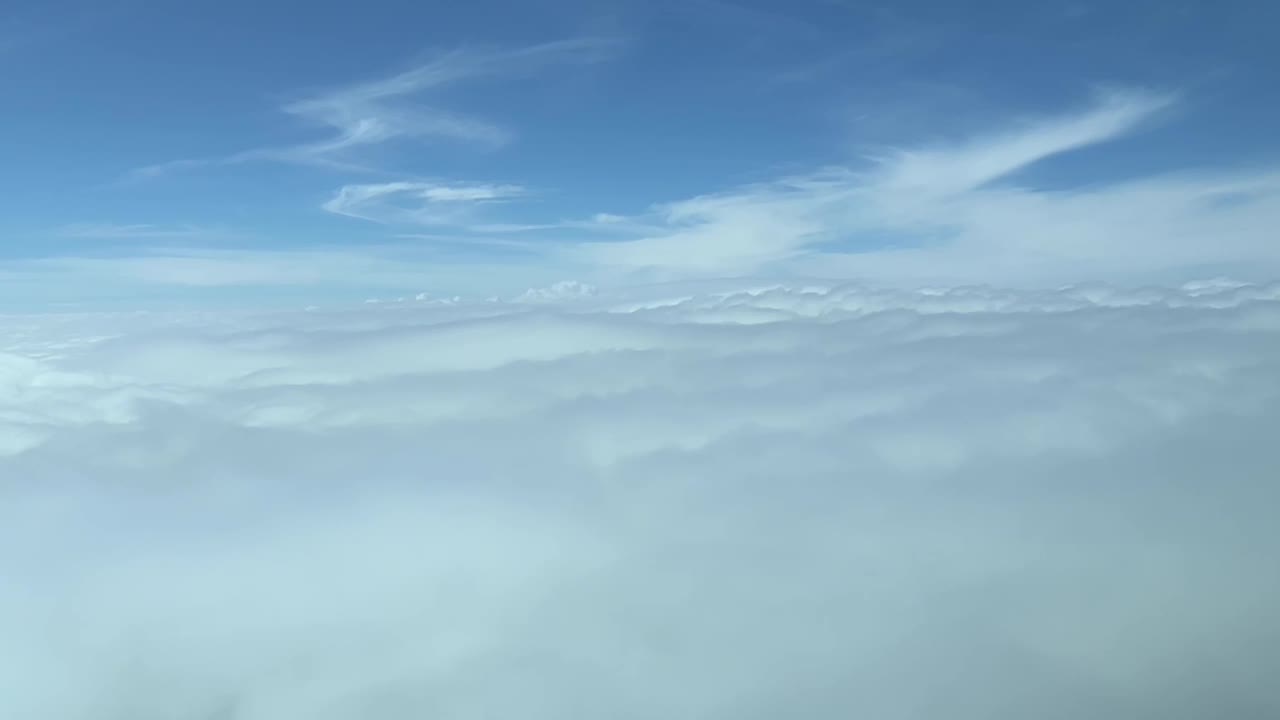 Cockpit view ocerflying a of a sea of clouds dayligh