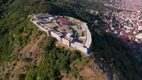 stone walls of castle standing above the beautiful city of prizren with red roof houses