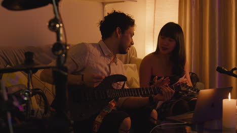 man and woman playing guitar together