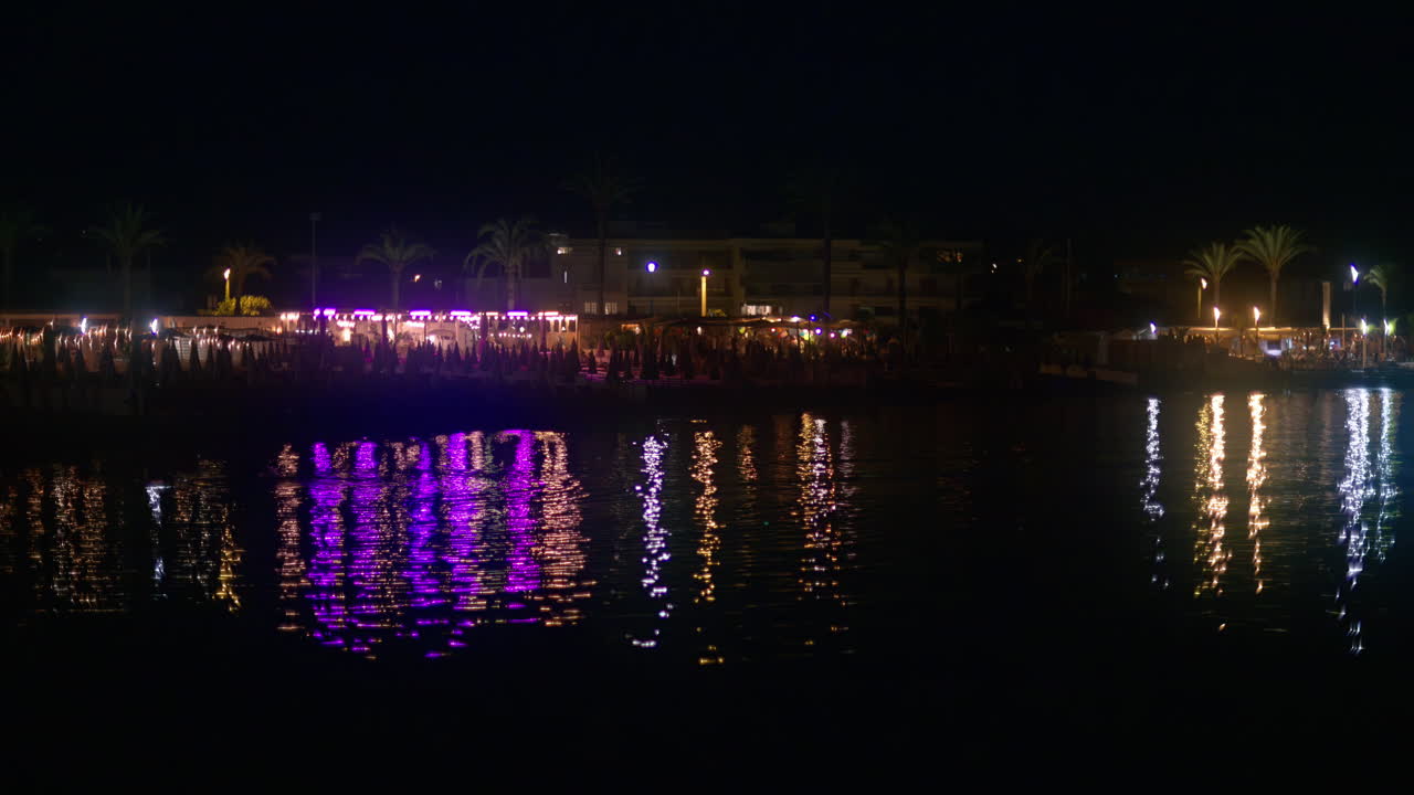 Lights reflecting in the sea at the beach at night