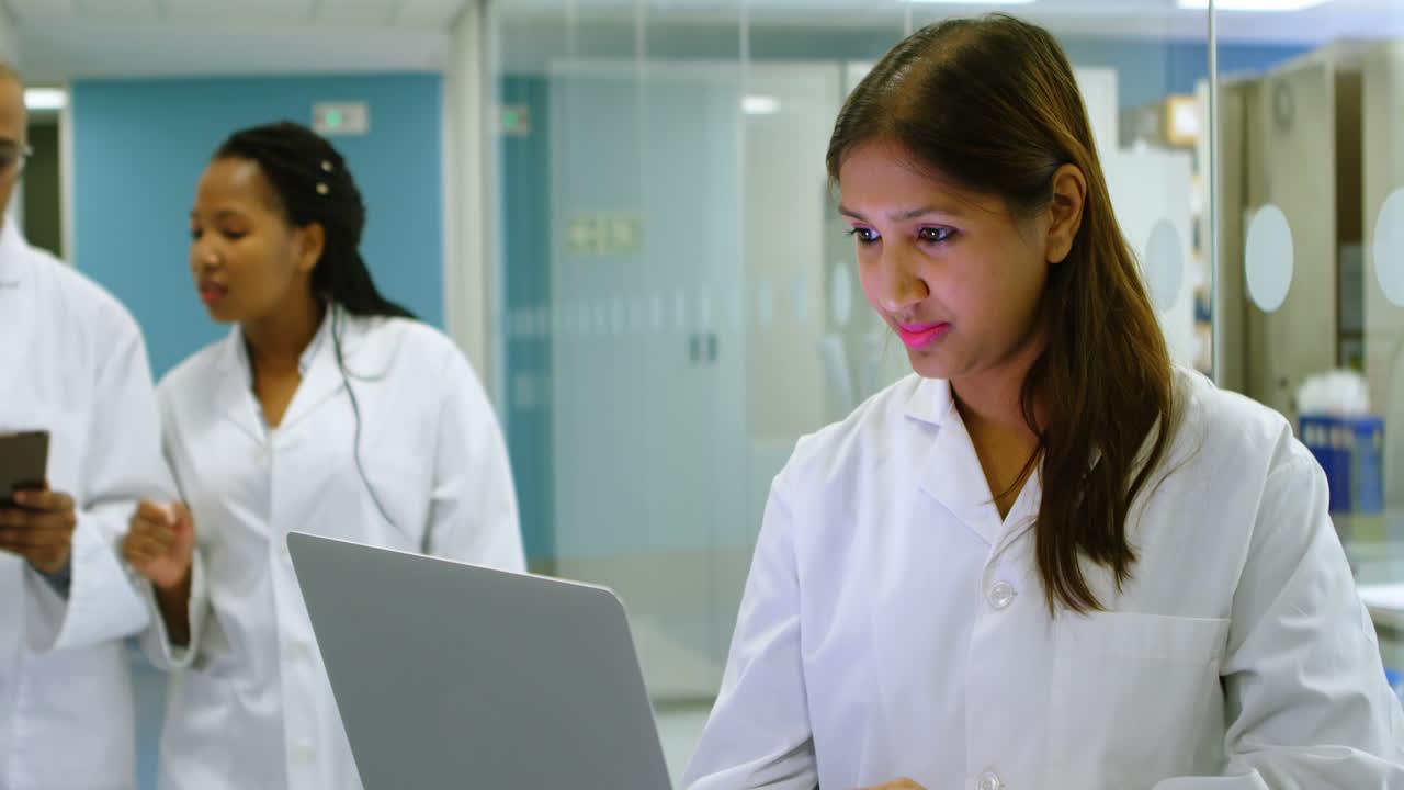 científico que usa una computadora portátil en la oficina 4k